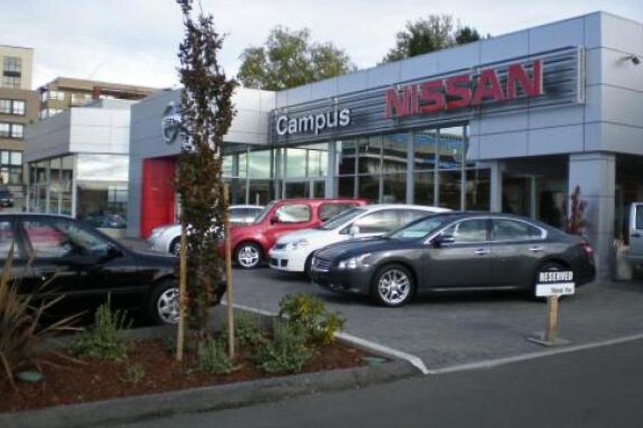 The exterior of Campus Nissan commercial property, designed by Alan Lowe Architecture with contemporary grey siding and large signage.