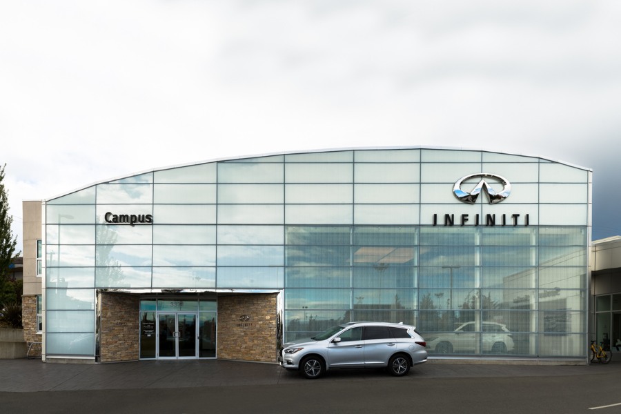 The exterior of Campus Infiniti commercial property, designed by Alan Lowe Architecture with large windows and brick features.