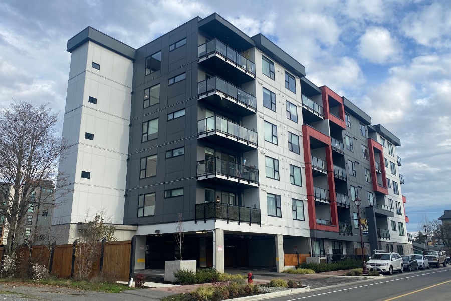 The Trilogy buildings, designed by Alan Lowe Architecture, in blue grey and red.