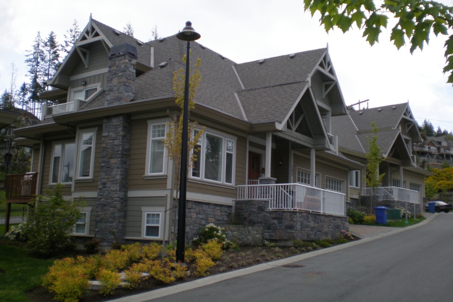 Troon Court Townhouse in a traditionally modern style with stonework and lighter coloured siding.